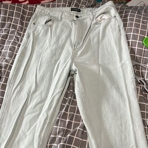 Very pale, light blue denim jeans with a small slit on the bottom